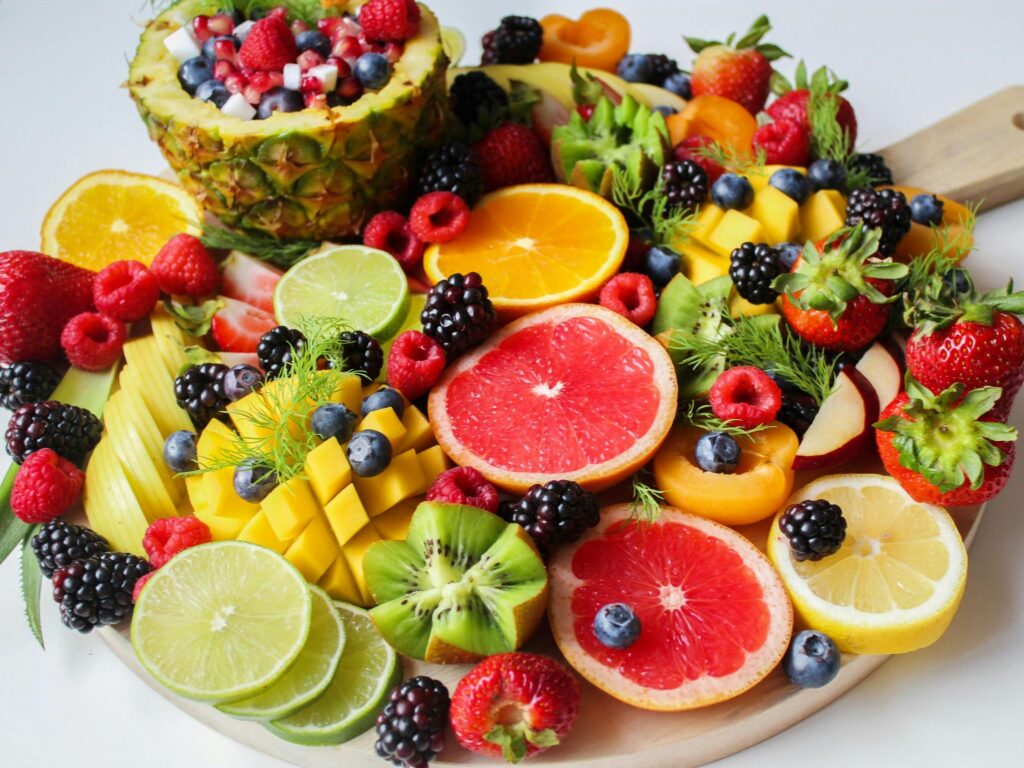 pexels-photo-1132047-1132047 A vibrant assortment of fresh berries and citrus fruits on a platter, showcasing the colorful ingredients for reaping their health benefits.