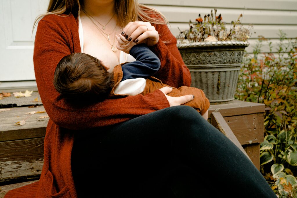 pexels-photo-3074935-3074935 Warm and caring scene of a mother nursing her infant in a peaceful porch setting, symbolizing the nurturing bond and responsible choices regarding breastfeeding and alcohol.
