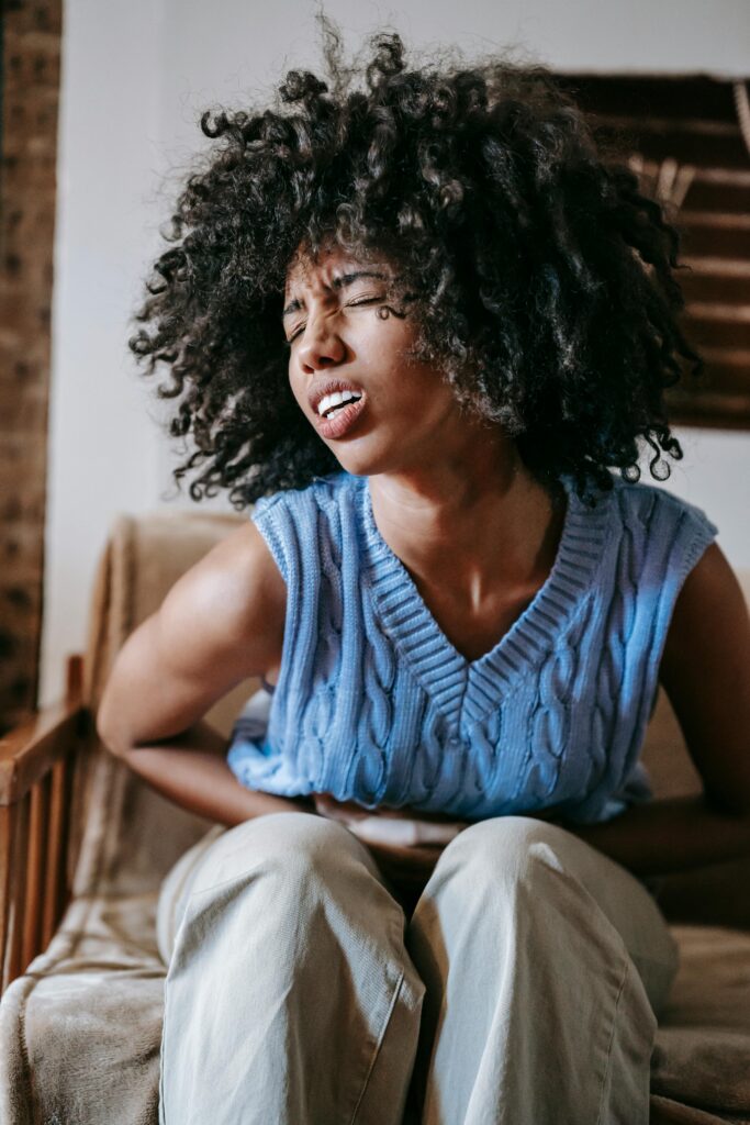 Young woman experiencing abdominal pain and discomfort from common diarrhea causes