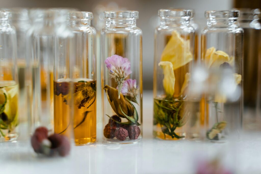 Close-up of dry flowers in glass vials showcasing flower essences for natural healing and wellness.