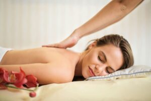 A woman receiving one of the massage techniques, effleurage, for deep relaxation, and decreasing swelling.