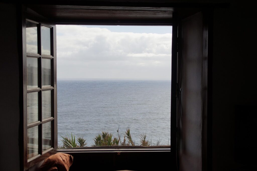 open-window-sea-view-lung-health-ventilation.jpg Window overlooking sea showing how fresh ocean air supports lung health and ventilation in living spaces