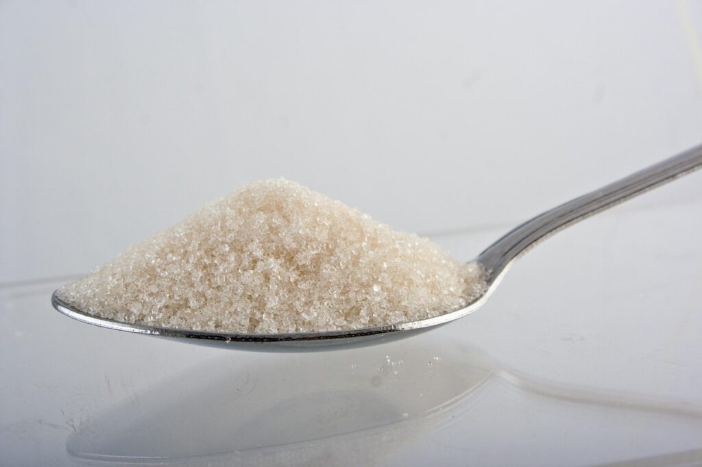 Refined white sugar is pure glucose, a primary contributor to the metabolic dangers discussed in historical health warnings. A pile of refined white sugar, illustrating the source of dietary glucose dangers.