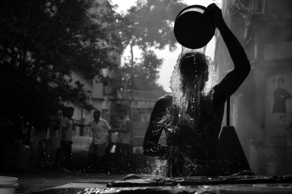 Person using a basin to pour cool water demonstrating the final step of the hot-to-cold morning bath routine Completing your routine with a cool rinse is key to sealing in the circulation and energy morning bath benefits.
