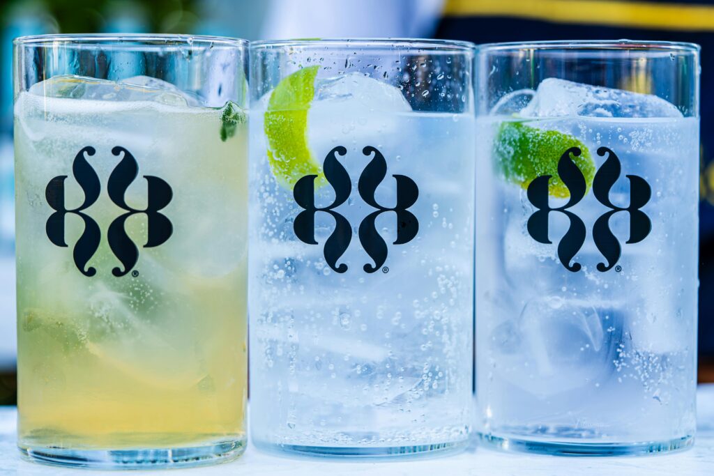 Though refreshing, icy drinks can shock digestion by lowering your body’s core temperature and slowing metabolism. Frosty glasses of iced sparkling water with lime, representing beverages that can impair nerve energy and body heat regulation.