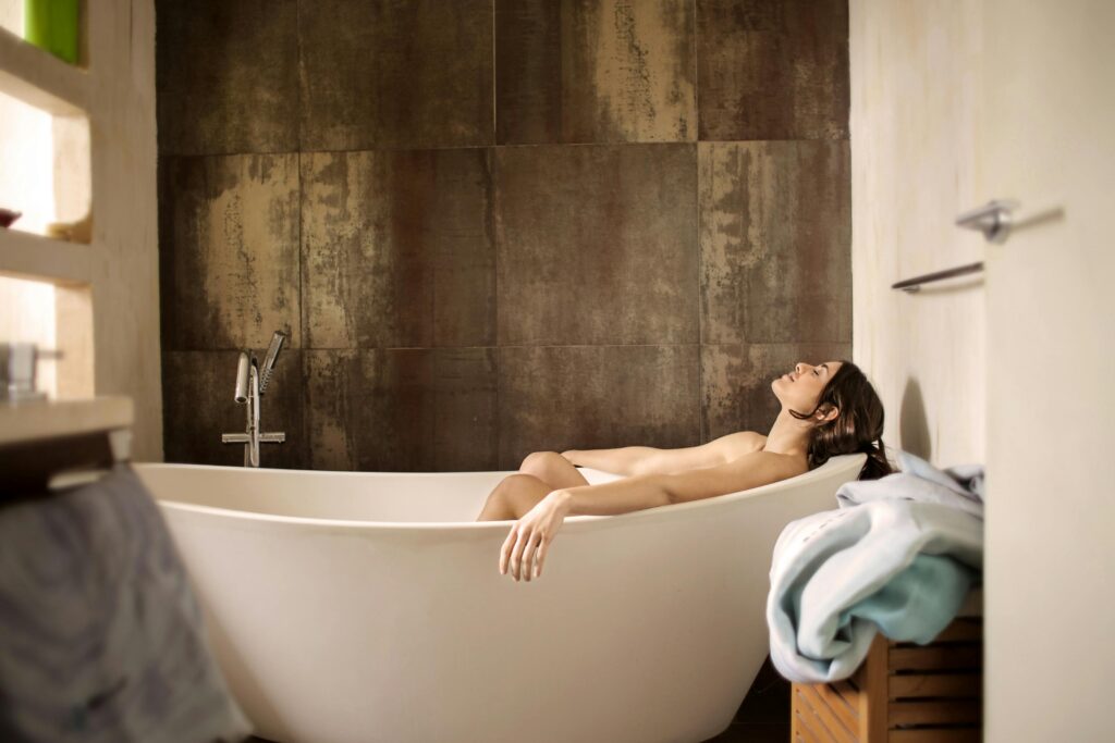 Morning bath benefits include deep relaxation, detox through gentle perspiration, and a fresh, energized start to your day. Woman enjoying a serene morning bath, illustrating morning bath benefits for relaxation, detox, and improved circulation.